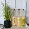 Glasflasche mit Spruch: "LET THE EVENING BEGIN" mit 5er LED-Beleuchtung (Batteriefach) – Bild 3